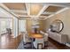 The dining room features a modern chandelier, large windows, and elegant furnishings creating a lovely atmosphere at 303 Laurel Hill Road, Chapel Hill, NC 27514