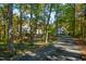 Long driveway leading to the house surrounded by forest at 303 Laurel Hill Road, Chapel Hill, NC 27514