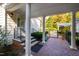 Charming home entrance with brick patio, white columns, and lush landscaping leads to a tranquil backyard oasis at 303 Laurel Hill Road, Chapel Hill, NC 27514