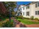 Charming home exterior with a brick walkway, manicured landscaping, and classic architectural details at 303 Laurel Hill Road, Chapel Hill, NC 27514