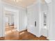 Bright foyer featuring hardwood floors, white paneled walls, arched doorway, and natural light at 303 Laurel Hill Road, Chapel Hill, NC 27514