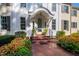 Inviting front entrance with a brick walkway, manicured landscaping, and an elegant arched doorway at 303 Laurel Hill Road, Chapel Hill, NC 27514