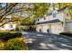Spacious three-car garage with adjacent covered walkway, surrounded by lush landscaping at 303 Laurel Hill Road, Chapel Hill, NC 27514