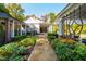 Lush garden featuring a variety of colorful plants, with a view of the home and covered walkway at 303 Laurel Hill Road, Chapel Hill, NC 27514