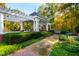 Picturesque gazebo surrounded by manicured gardens and a tree-lined backdrop, perfect for relaxation at 303 Laurel Hill Road, Chapel Hill, NC 27514