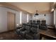 Private home theater boasts tiered seating, a projector, and bar, perfect for movie nights and entertaining guests at 303 Laurel Hill Road, Chapel Hill, NC 27514