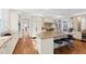 A chef's kitchen featuring white cabinets, a granite island, and stainless appliances at 303 Laurel Hill Road, Chapel Hill, NC 27514