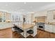 Gourmet kitchen with granite countertops, a center island, and professional-grade stainless-steel appliances at 303 Laurel Hill Road, Chapel Hill, NC 27514
