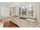 Well-lit kitchen with granite counters, ample cabinetry, stainless steel sink, and a view of the outdoors at 303 Laurel Hill Road, Chapel Hill, NC 27514