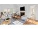 Bright living room with a fireplace, large TV, and lots of seating at 303 Laurel Hill Road, Chapel Hill, NC 27514