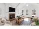 Bright living room with a fireplace, a large TV, and vaulted ceilings at 303 Laurel Hill Road, Chapel Hill, NC 27514