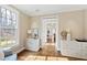 Living room featuring wood floors and view to another room at 303 Laurel Hill Road, Chapel Hill, NC 27514