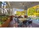 Covered outdoor dining with poolside view features a brick patio, a fan, and elegant patio furniture at 303 Laurel Hill Road, Chapel Hill, NC 27514