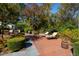 Beautiful brick patio with lounge chairs and lush landscaping at 303 Laurel Hill Road, Chapel Hill, NC 27514