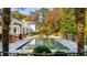 Beautiful pool area with integrated seating and a lush garden setting, ideal for outdoor enjoyment at 303 Laurel Hill Road, Chapel Hill, NC 27514