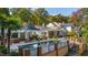 Inviting pool and spa with a covered outdoor area, complemented by lush landscaping and solar panels at 303 Laurel Hill Road, Chapel Hill, NC 27514