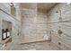Close up of the glass enclosed tiled shower with bench and dual shower heads at 303 Laurel Hill Road, Chapel Hill, NC 27514