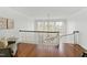 Second story landing with railing overlooking a winding staircase and floor to ceiling windows at 303 Laurel Hill Road, Chapel Hill, NC 27514