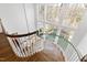 A winding staircase featuring wood steps and white railings with a chandelier at 303 Laurel Hill Road, Chapel Hill, NC 27514