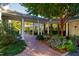 Brick walkway and covered path leading to the home, surrounded by meticulously kept gardens at 303 Laurel Hill Road, Chapel Hill, NC 27514