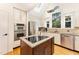 Well-equipped kitchen with granite countertops, stainless steel appliances, and central island at 315 Westbrook Dr, Carrboro, NC 27510