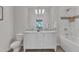 Bright bathroom featuring a double vanity with marble countertop, shower, and decorative tile accents at 319 Fayetteville St # 509, Raleigh, NC 27601