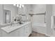 Bright bathroom featuring a double vanity with marble countertop, shower, and decorative tile accents at 319 Fayetteville St # 509, Raleigh, NC 27601