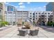 Well-appointed building courtyard with modern design elements, outdoor furniture, and greenery at 319 Fayetteville St # 509, Raleigh, NC 27601