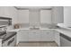 Contemporary kitchen with quartz countertops, stainless steel appliances, and white cabinetry at 319 Fayetteville St # 509, Raleigh, NC 27601