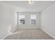 Well-lit bedroom featuring neutral carpet and two windows providing plenty of natural light at 3517 Strawberry Patch Row, Raleigh, NC 27604