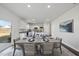 Beautiful dining area with open floorplan flowing to the modern kitchen with white cabinetry at 3517 Strawberry Patch Row, Raleigh, NC 27604
