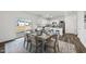 Dining room with stylish table set for six, seamlessly connecting to the kitchen and outdoor patio at 3517 Strawberry Patch Row, Raleigh, NC 27604