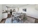 Beautiful dining area with open floorplan flowing to the modern kitchen with white cabinetry at 3517 Strawberry Patch Row, Raleigh, NC 27604