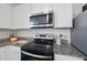 Kitchen featuring granite countertops, stainless steel appliances, and white cabinetry at 3517 Strawberry Patch Row, Raleigh, NC 27604