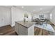 Stylish kitchen island with granite countertops, white cabinetry, and an open layout to the dining area at 3517 Strawberry Patch Row, Raleigh, NC 27604