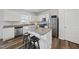 Modern kitchen with a granite island, stainless steel appliances, and ample storage at 3517 Strawberry Patch Row, Raleigh, NC 27604