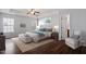 Beautiful bedroom with tray ceilings, wood floors, a large bed, and matching furniture at 3614 Kilgo Dr, Durham, NC 27705