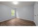 Bedroom featuring natural sunlight, and hardwood flooring throughout at 3614 Kilgo Dr, Durham, NC 27705