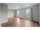Bright, airy bedroom featuring hardwood floors and large windows at 3614 Kilgo Dr, Durham, NC 27705