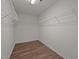 Spacious walk-in closet with wire racks and hardwood floors at 3614 Kilgo Dr, Durham, NC 27705