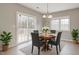 Charming dining area with sliding doors to the deck, hardwood flooring and modern light fixture at 3614 Kilgo Dr, Durham, NC 27705
