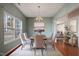 Elegant dining room featuring a chandelier, a large window, and stylish decor with hardwood flooring at 3614 Kilgo Dr, Durham, NC 27705