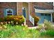 A two-story brick home with colorful landscaping, a two-car garage, and a welcoming entrance at 3614 Kilgo Dr, Durham, NC 27705