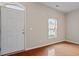 Bright foyer with hardwood floors, a white front door, and a window with a view at 3614 Kilgo Dr, Durham, NC 27705