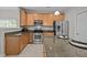 Updated kitchen featuring granite countertops, stainless steel appliances, a large island, and ample cabinet space at 3614 Kilgo Dr, Durham, NC 27705