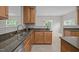 Modern kitchen featuring granite countertops, stainless steel appliances, ample cabinetry, and an open layout at 3614 Kilgo Dr, Durham, NC 27705