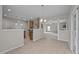 Open concept kitchen with an island, granite countertops, and stainless steel appliances, seamlessly connects to the living area at 3614 Kilgo Dr, Durham, NC 27705