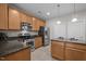 Modern kitchen featuring granite countertops, stainless steel appliances, a kitchen island, and ample cabinet space at 3614 Kilgo Dr, Durham, NC 27705