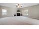 Spacious living room with a fireplace, neutral carpet, and plenty of natural light from the large windows at 3614 Kilgo Dr, Durham, NC 27705