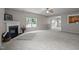 Spacious living room with a fireplace, large windows, and open floorplan with carpet flooring at 3614 Kilgo Dr, Durham, NC 27705